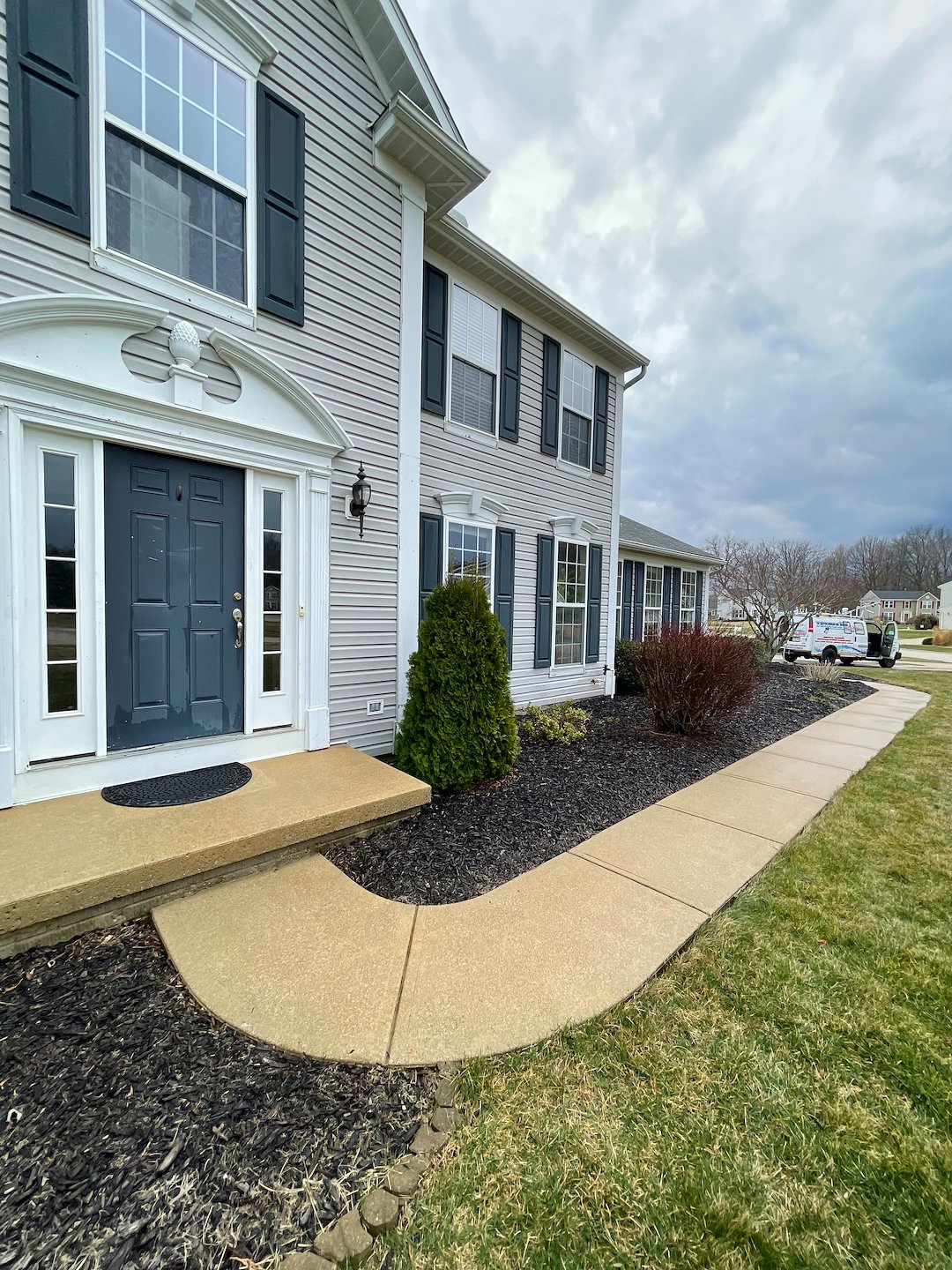 Professional Pressure Washing and Soft Washing on a vinyl sided home, walkway and driveway in Sheffield Lake, Oh. 